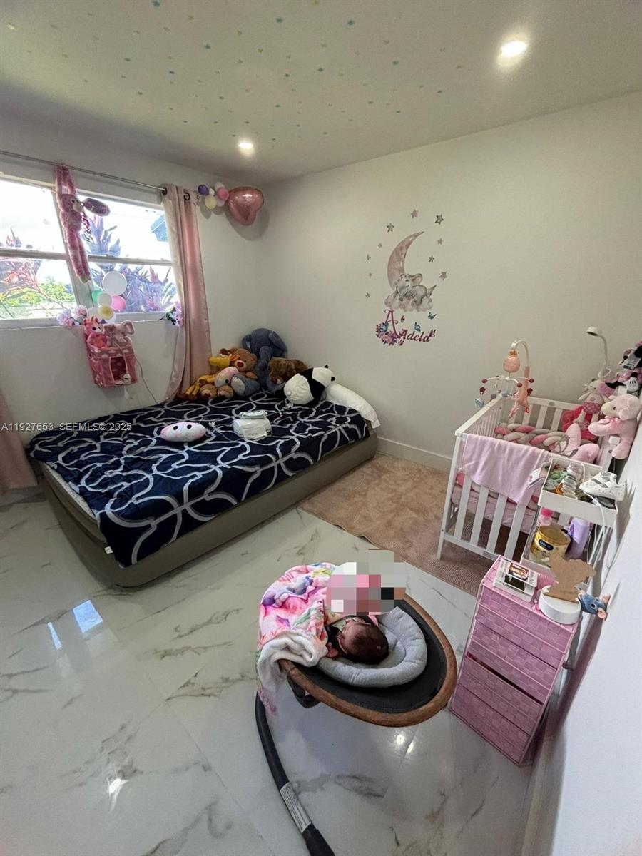 21160 Southwest 328th Street Homestead, FL 33030 - Photo 3 of 18 a kitchen with a stove and a chair