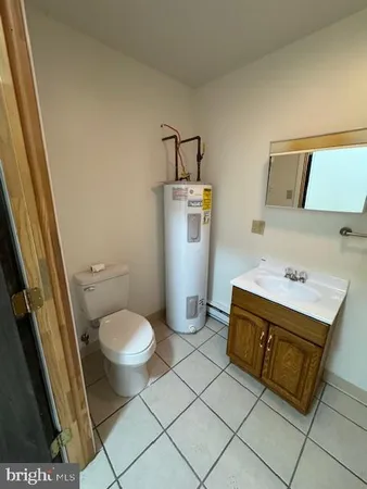a bathroom with a sink toilet and mirror