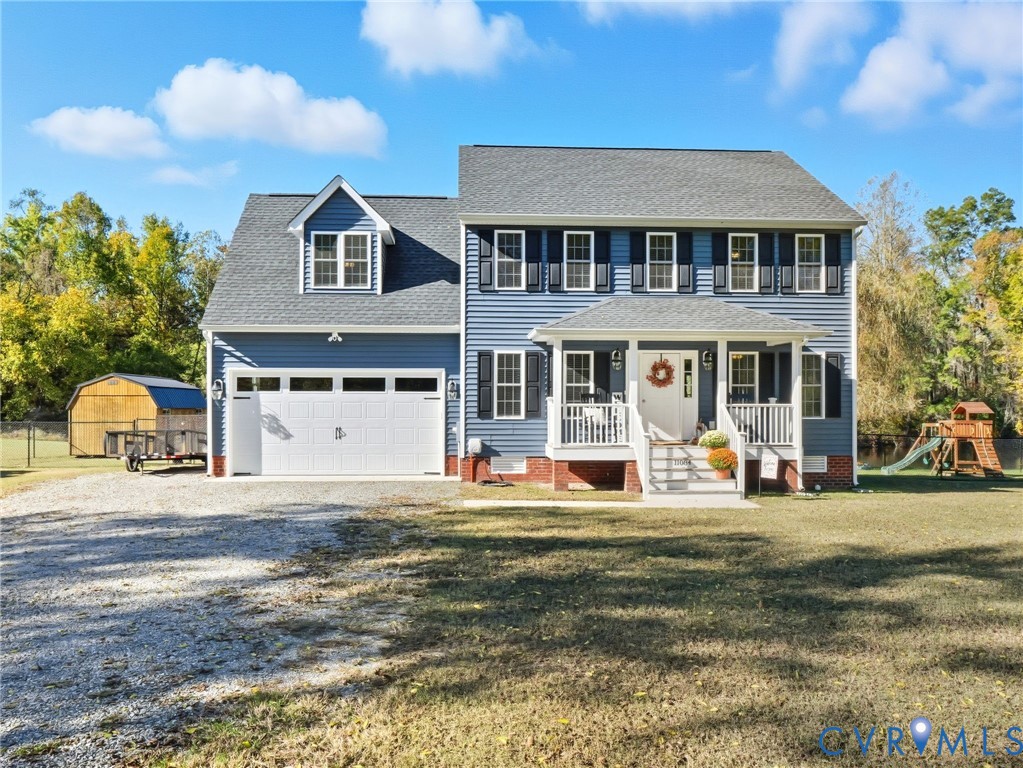 11084 West River Road Aylett, VA 23009 - Photo 1 of 36 a front view of a house with a garden and trees