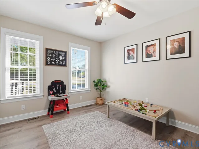 a bedroom with bed couch and window