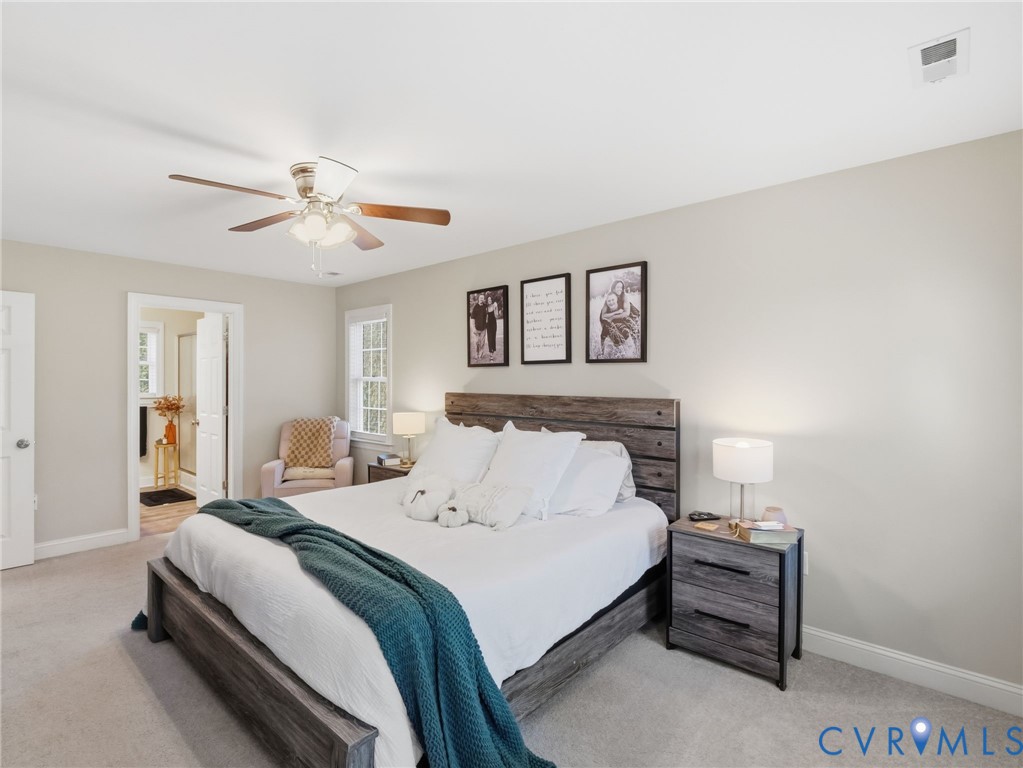 11084 West River Road Aylett, VA 23009 - Photo 18 of 36 a bedroom with a bed and a chandelier