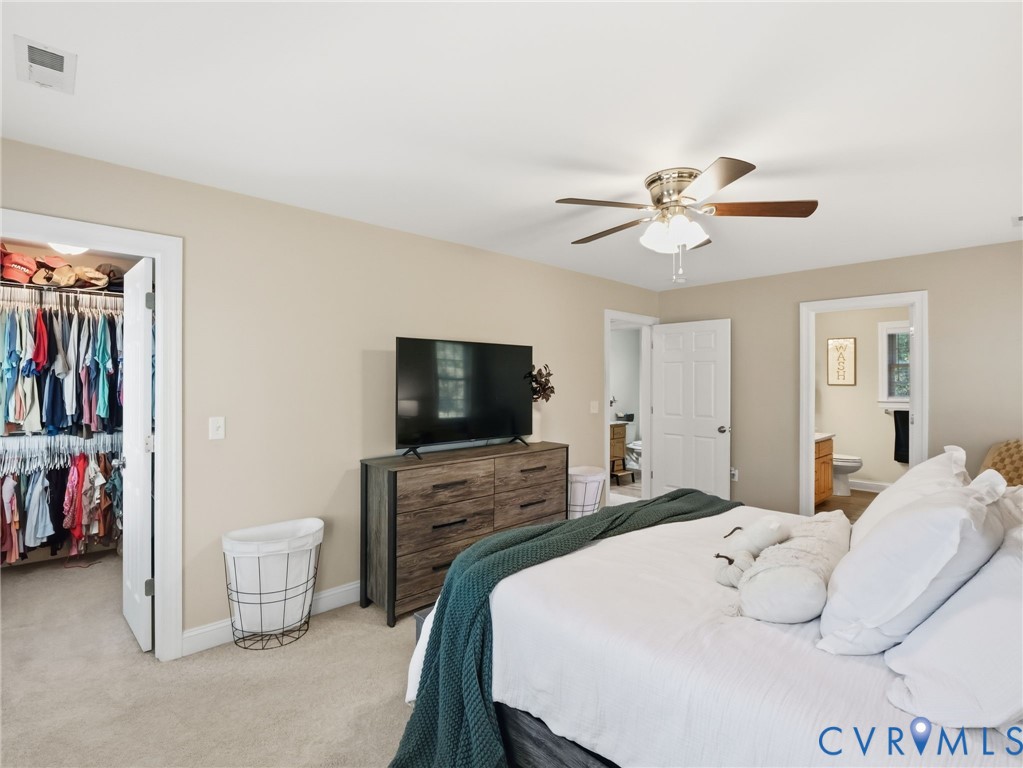 11084 West River Road Aylett, VA 23009 - Photo 19 of 36 a bedroom with a bed and a flat screen tv