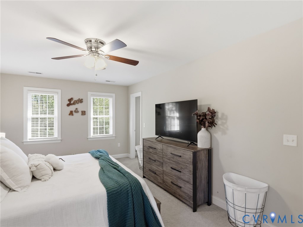 11084 West River Road Aylett, VA 23009 - Photo 20 of 36 a bedroom with a bed and a flat screen tv