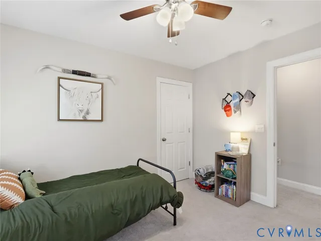 a bedroom with a bed mirror and window
