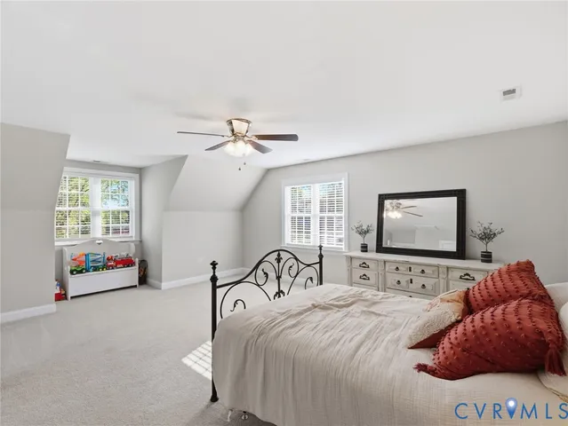 a bedroom with a bed and a large mirror