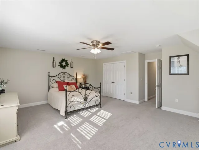 a spacious bedroom with a bed and a window