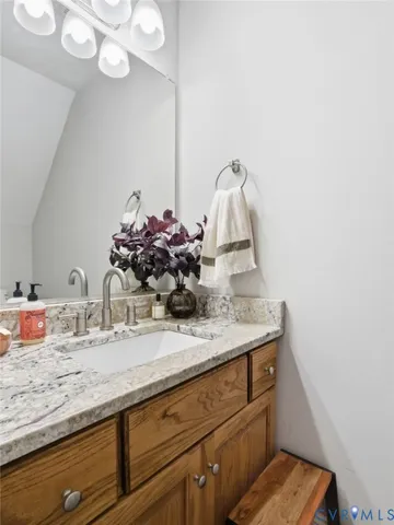 a bathroom with a double vanity sink toilet and shower