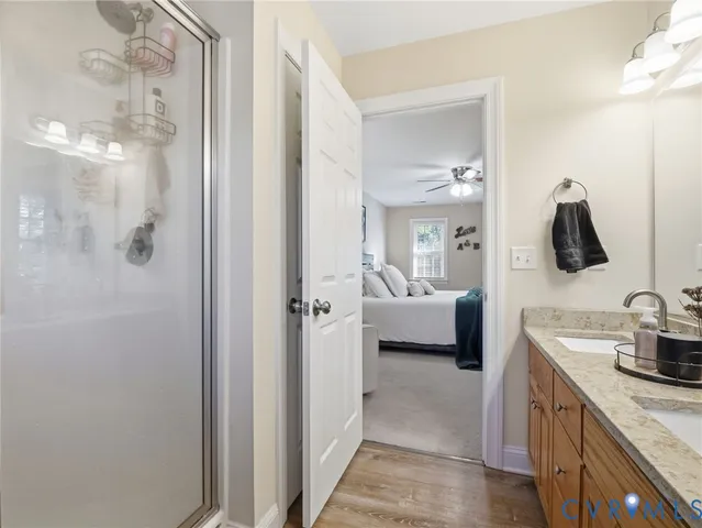 a bathroom with a granite countertop sink a toilet and a large mirror