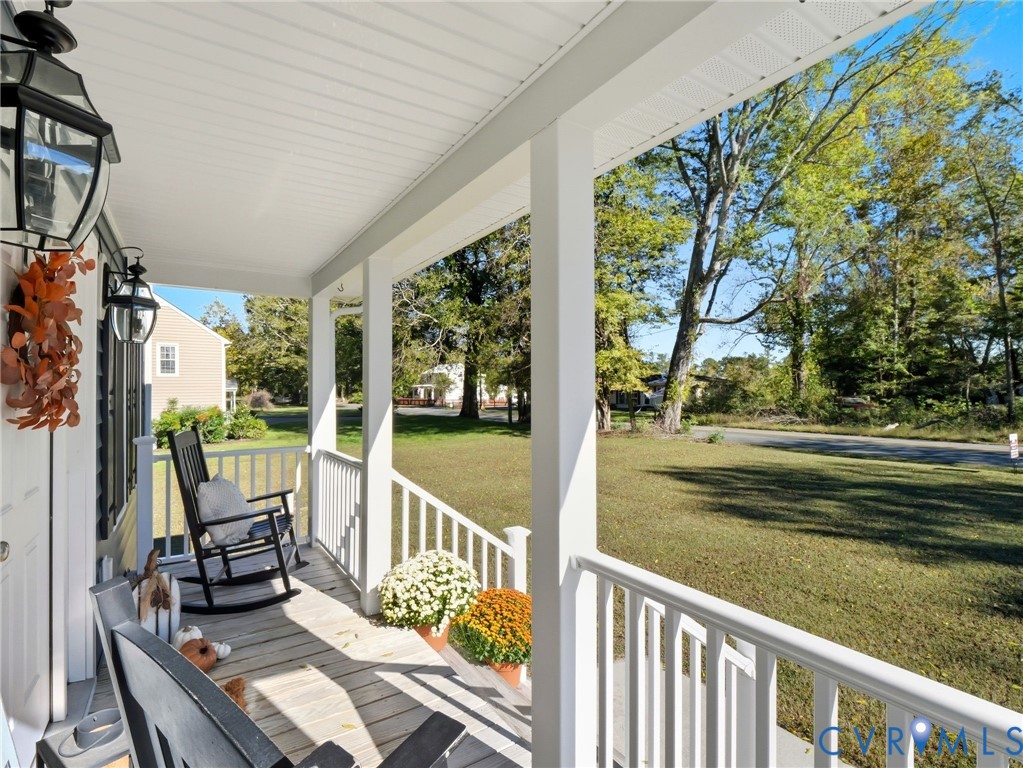11084 West River Road Aylett, VA 23009 - Photo 3 of 36 a view of balcony with wooden floor and outdoor seating