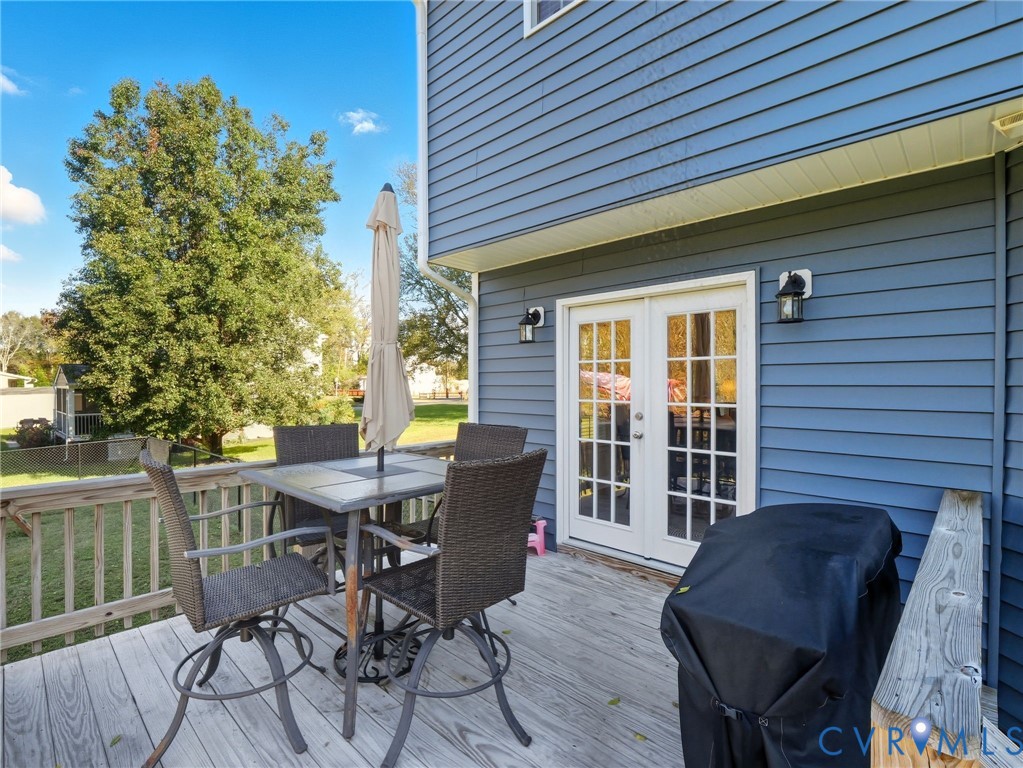 11084 West River Road Aylett, VA 23009 - Photo 33 of 36 a view of a deck with table and chairs and wooden floor