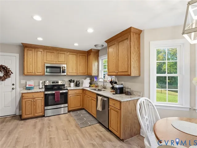 a large white kitchen with a sink and cabinets