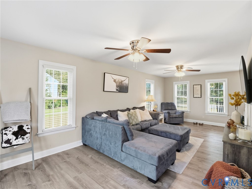 11084 West River Road Aylett, VA 23009 - Photo 9 of 36 a living room with furniture ceiling fan and a window
