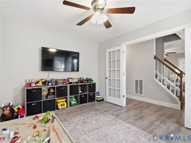 a view of a livingroom with workspace and a window