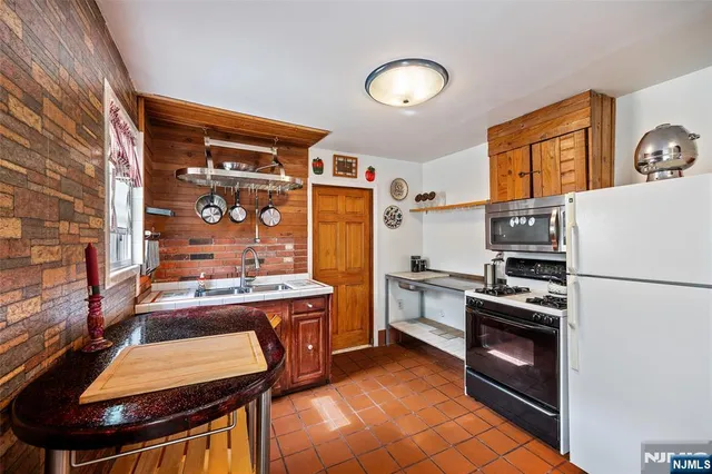 a kitchen with stainless steel appliances granite countertop a stove and a refrigerator