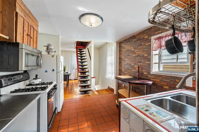 a kitchen that has a sink and a stove