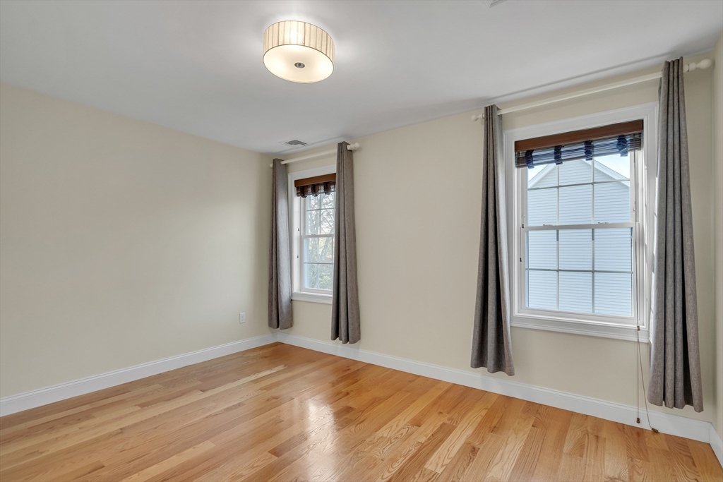 19 3rd Road Woburn, MA 01801 - Photo 22 of 41 an empty room with wooden floor and windows