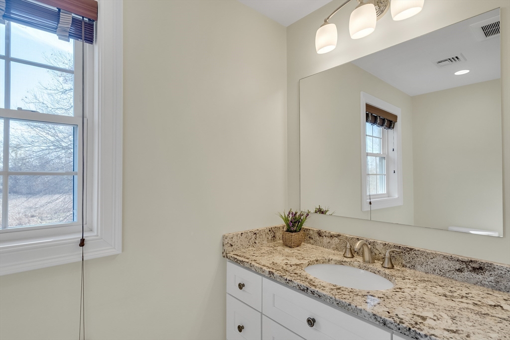 19 3rd Road Woburn, MA 01801 - Photo 25 of 41 a bathroom with a granite countertop sink and a mirror