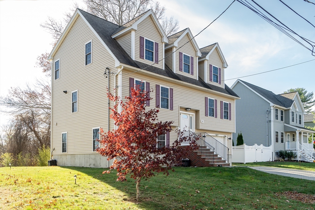 19 3rd Road Woburn, MA 01801 - Photo 3 of 41 a front view of a house with a garden and plants