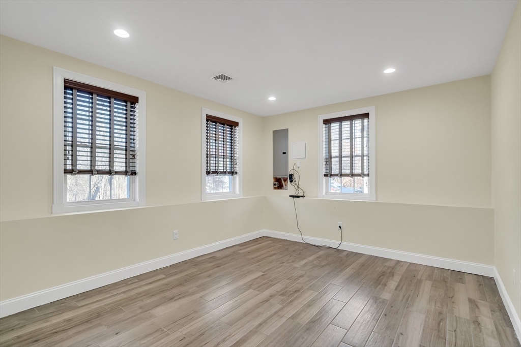 19 3rd Road Woburn, MA 01801 - Photo 32 of 41 an empty room with wooden floor and windows