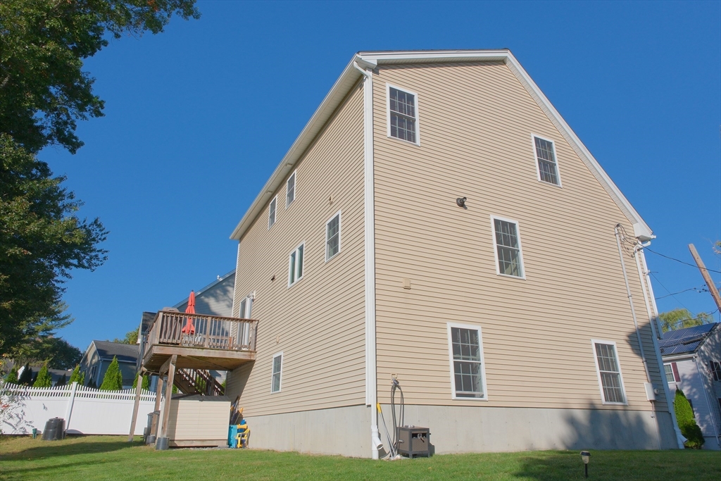 19 3rd Road Woburn, MA 01801 - Photo 36 of 41 a view of a white house with a yard and plants
