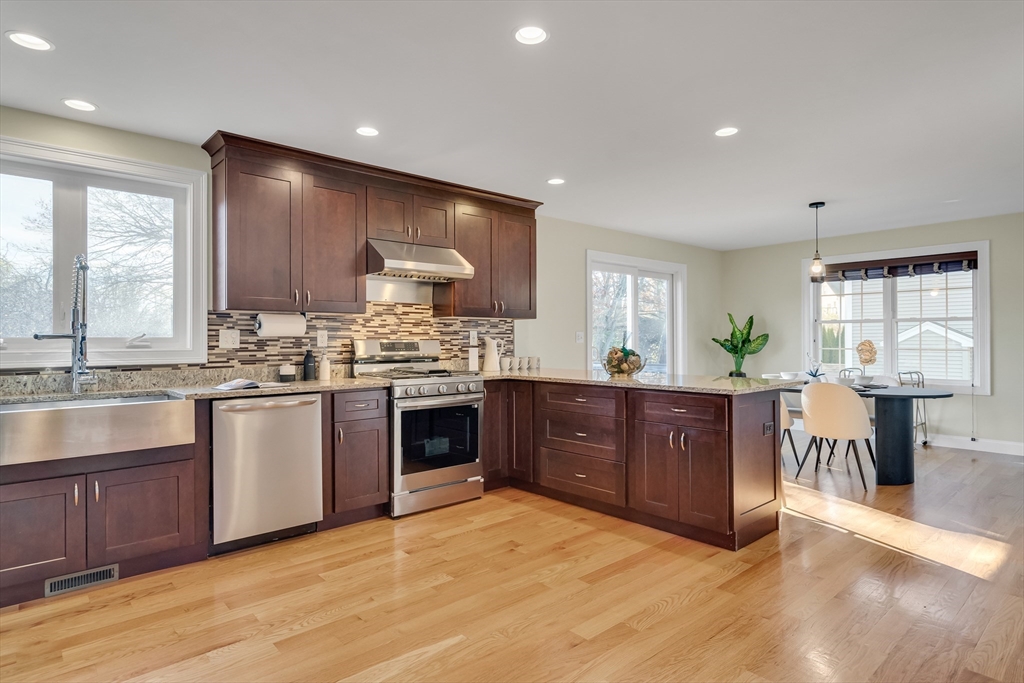 19 3rd Road Woburn, MA 01801 - Photo 5 of 41 a kitchen with stainless steel appliances kitchen island granite countertop a stove a sink a refrigerator and cabinets