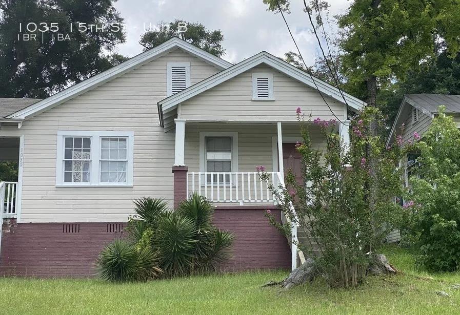 1035 15th Street, Unit B Columbus, GA 31901 - Photo 1 of 8 a front view of a house with garden