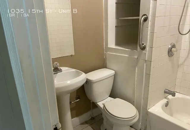 a white toilet sitting next to a bathroom sink