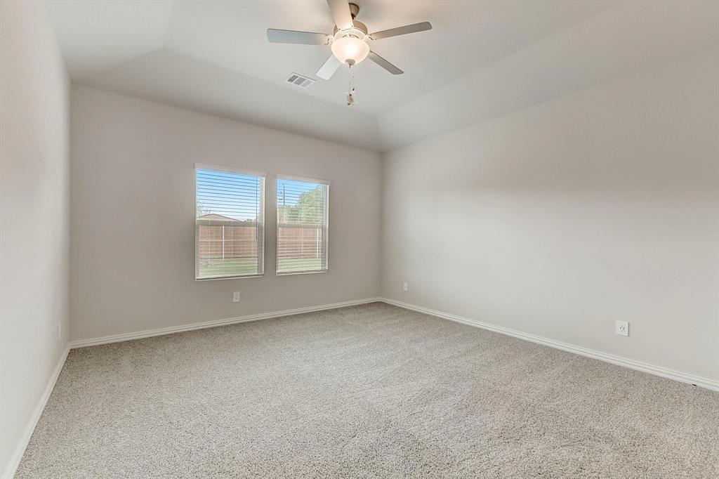 1405 Winters Way McKinney, TX 75071 - Photo 30 of 32 Carpeted spare room with ceiling fan and vaulted ceiling
