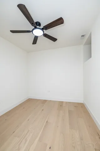 an empty room with closet and windows