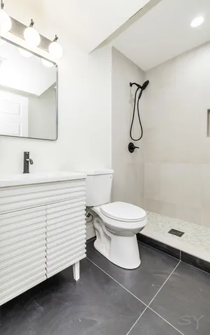 a bathroom with a toilet and a shower