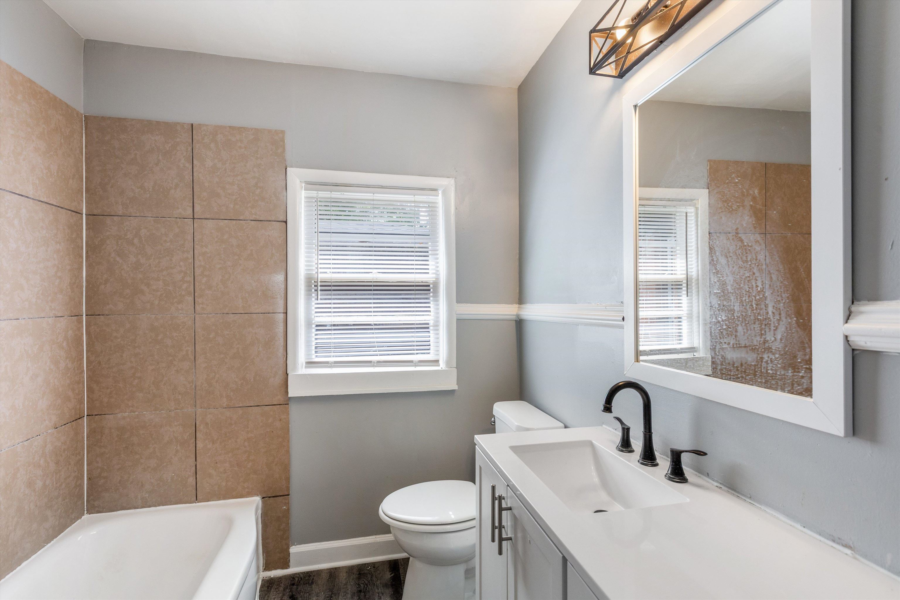 1387 Oak Ridge Drive Memphis, TN 38111 - Photo 5 of 11 a bathroom with a sink toilet and shower