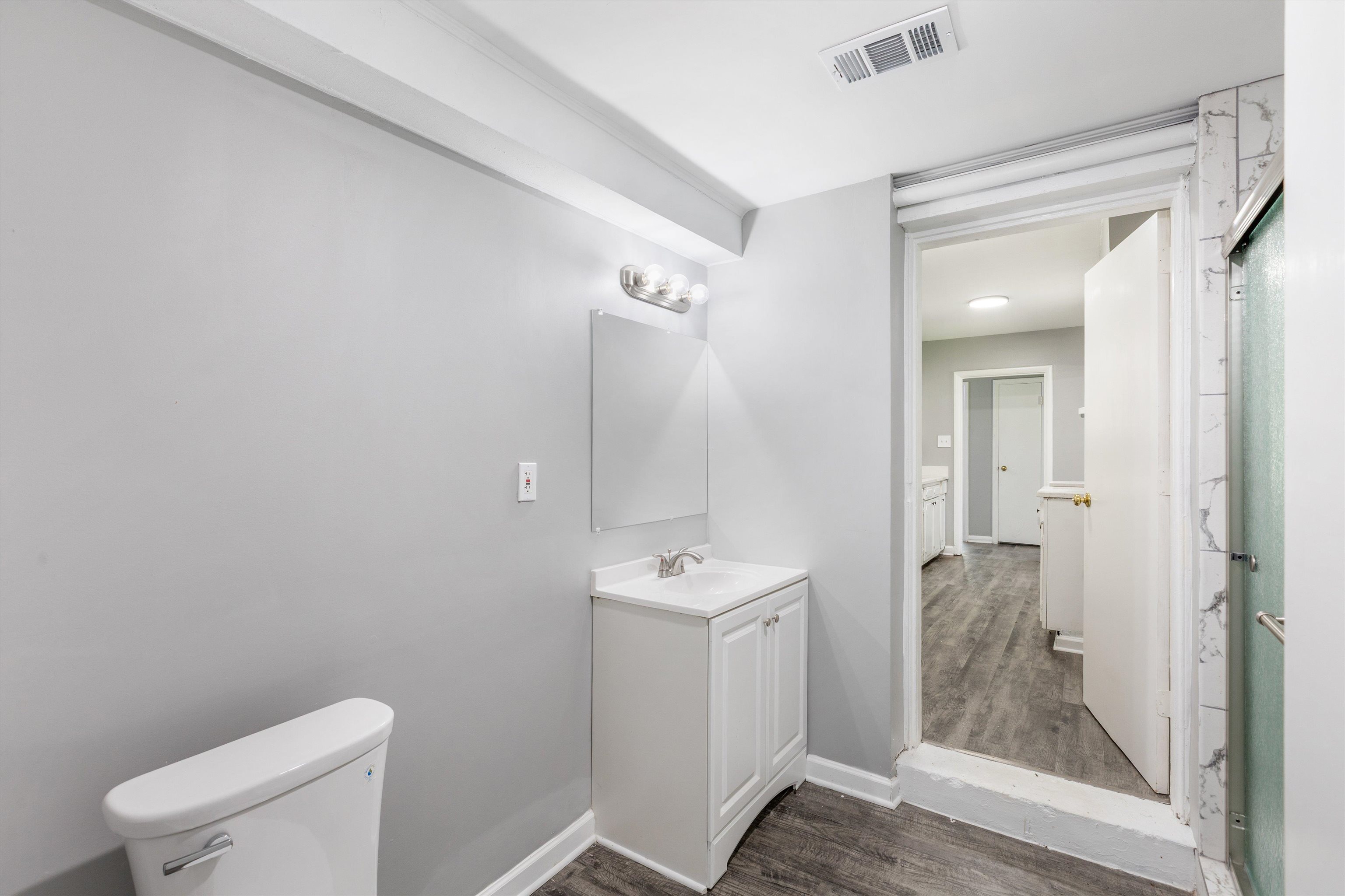 1387 Oak Ridge Drive Memphis, TN 38111 - Photo 7 of 11 a bathroom with a sink a toilet a mirror and shower