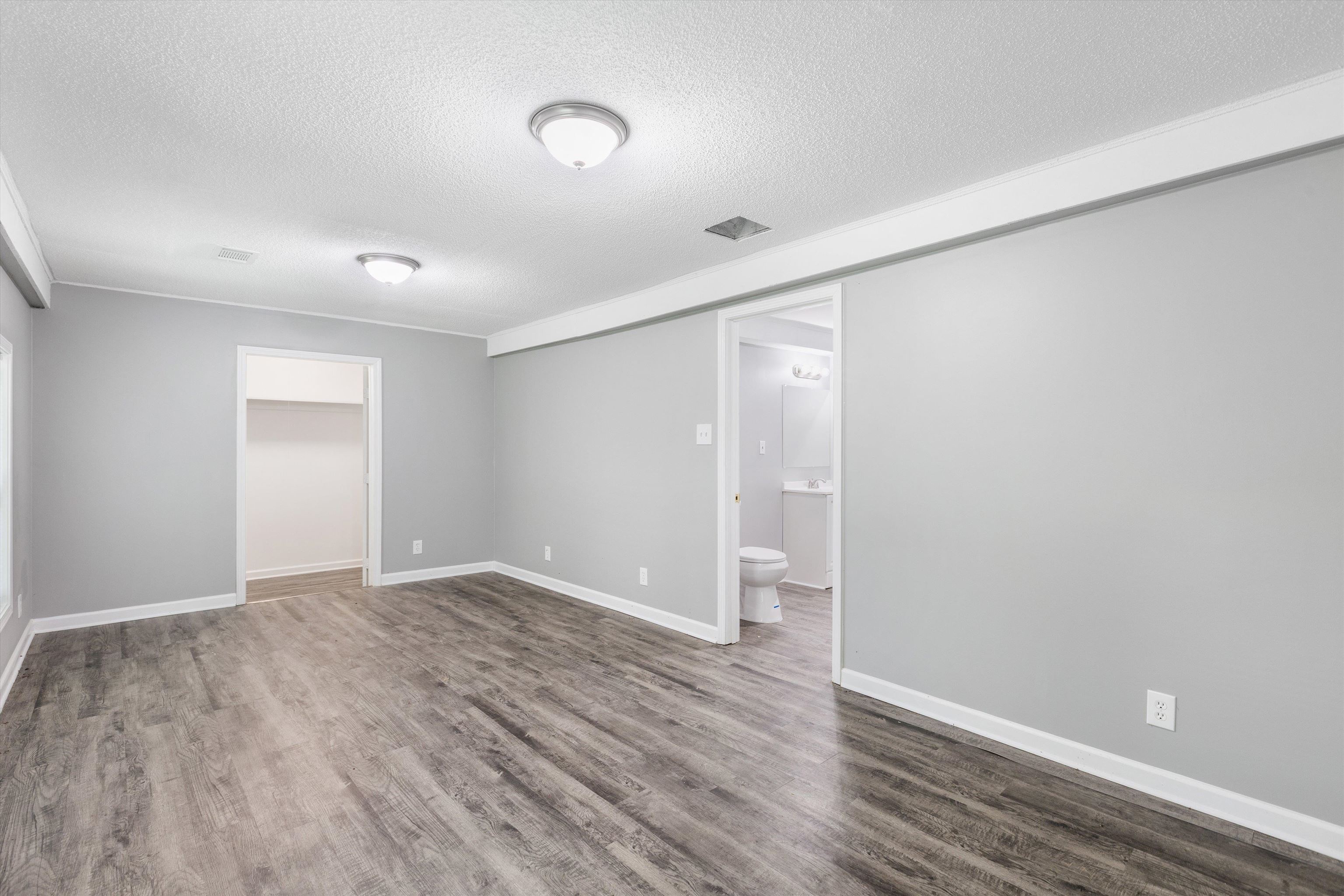 1387 Oak Ridge Drive Memphis, TN 38111 - Photo 9 of 11 wooden floor in an empty room with a window