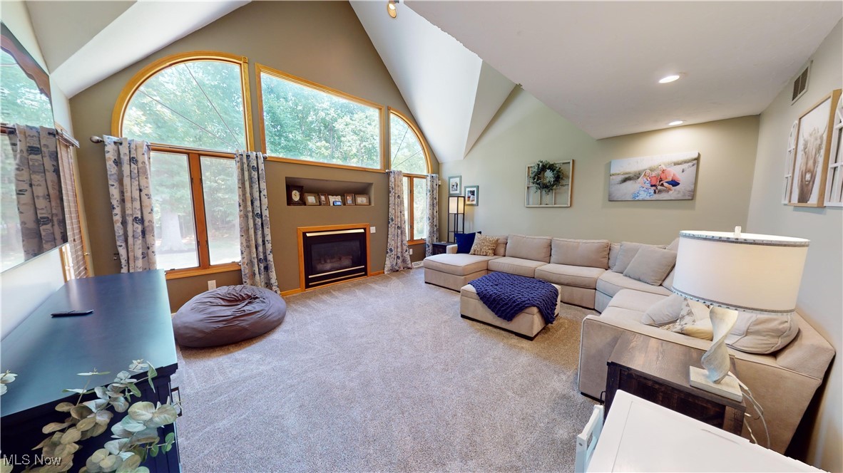 571 Ledge Road Macedonia, OH 44056 - Photo 14 of 35 Carpeted living room with high vaulted ceiling