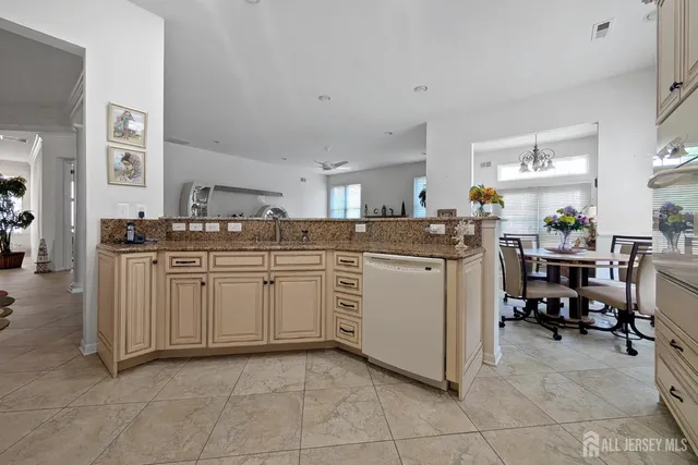 a kitchen with cabinets and chairs