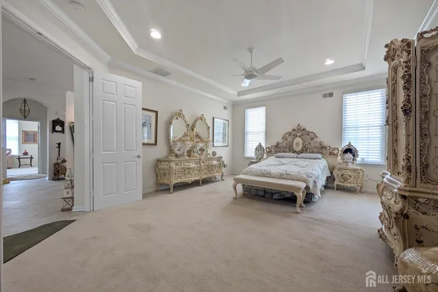 a spacious bedroom with a bed and a couch