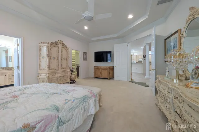 a spacious bedroom with a bed and glass wall door