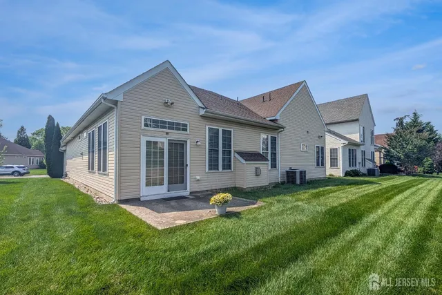 a front view of a house with a garden and yard