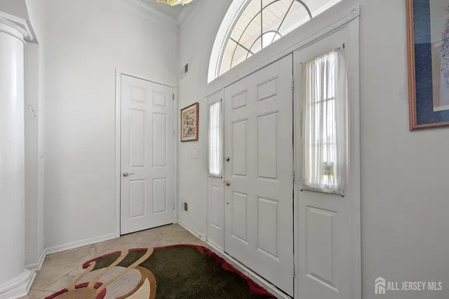 a hallway with white walls and wooden floor