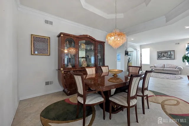 a view of a dining room with furniture and chandelier