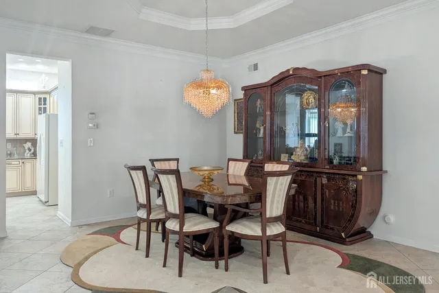 a view of a dining room with furniture and chandelier