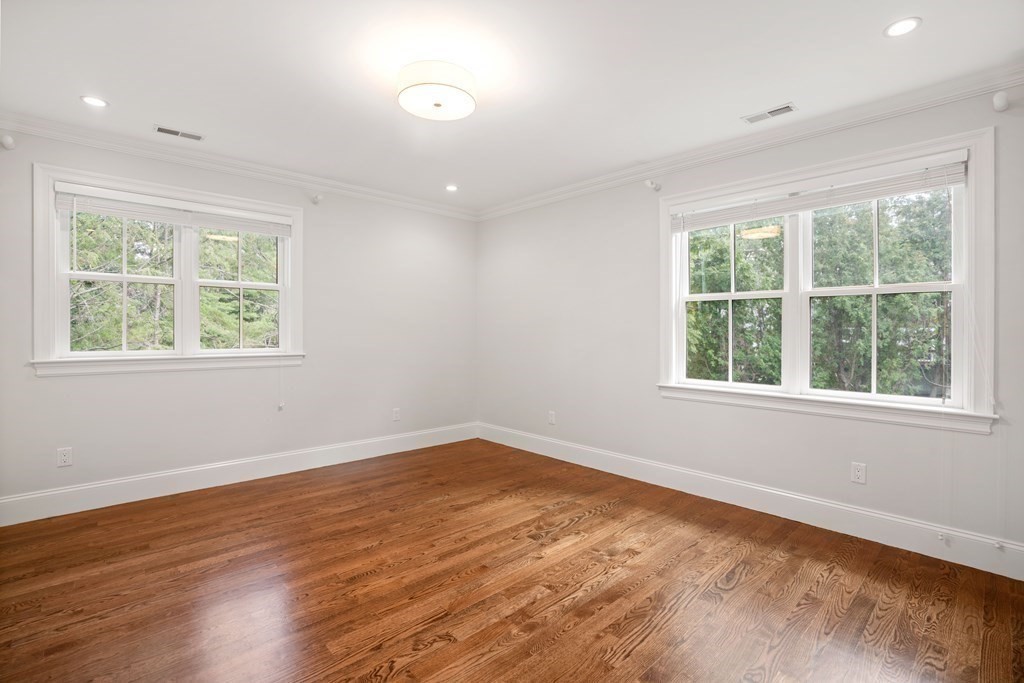 38 Wendell Road Newton, MA 02459 - Photo 28 of 42 an empty room with wooden floor and windows