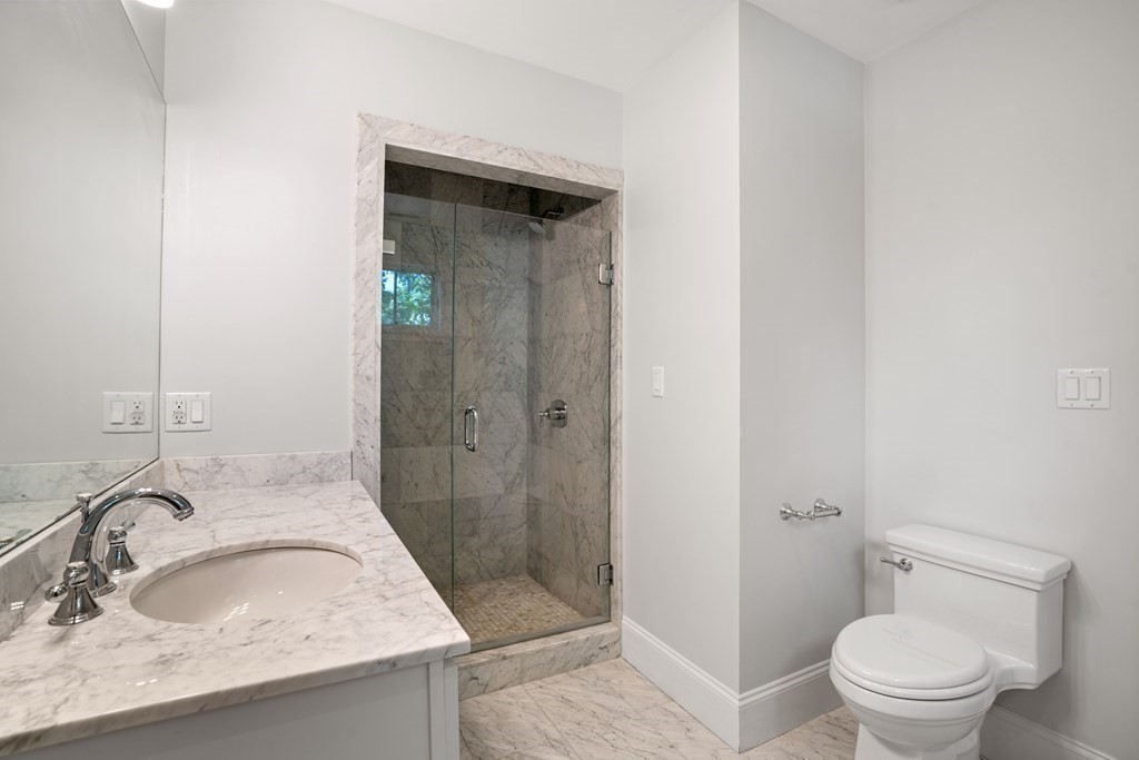 38 Wendell Road Newton, MA 02459 - Photo 30 of 42 a bathroom with a granite countertop sink toilet and shower