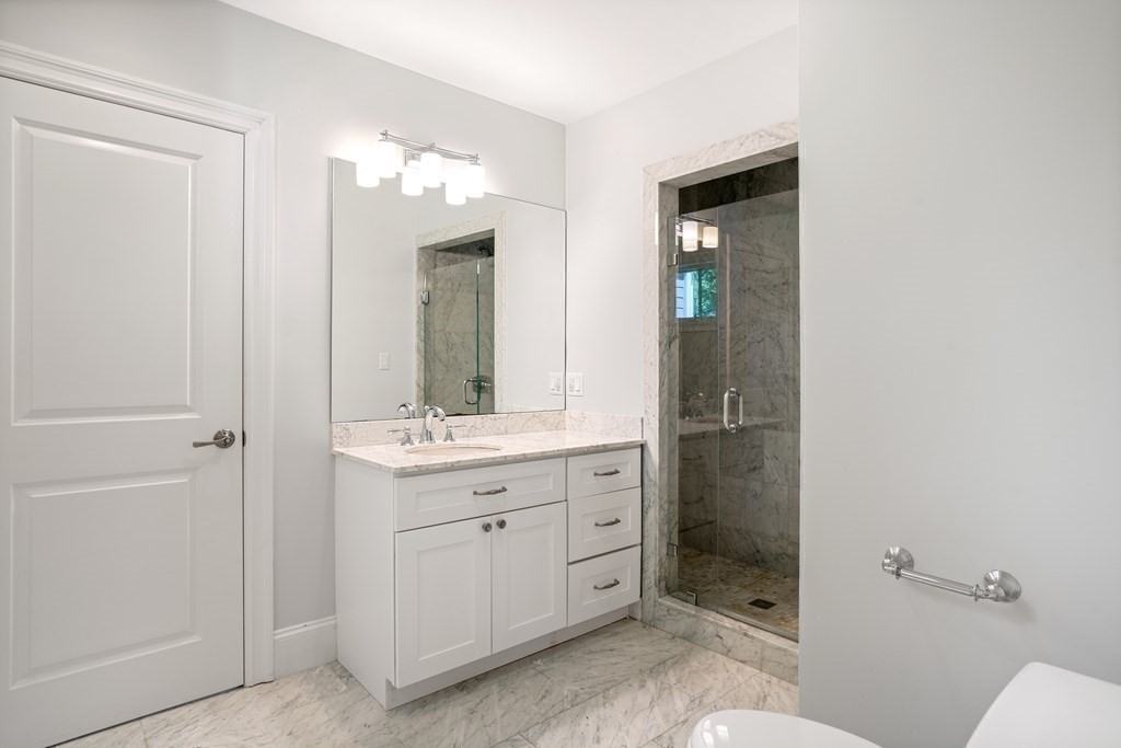 38 Wendell Road Newton, MA 02459 - Photo 31 of 42 a bathroom with a double vanity sink toilet and shower