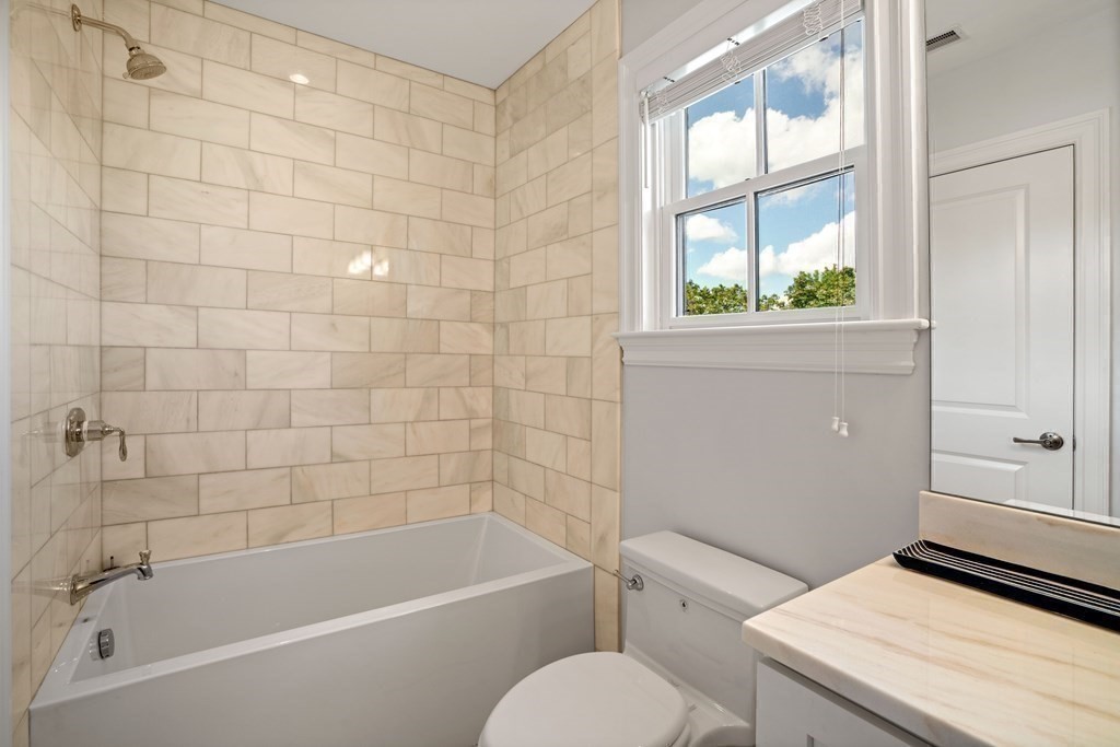 38 Wendell Road Newton, MA 02459 - Photo 33 of 42 a bathroom with a granite countertop bathtub toilet and window