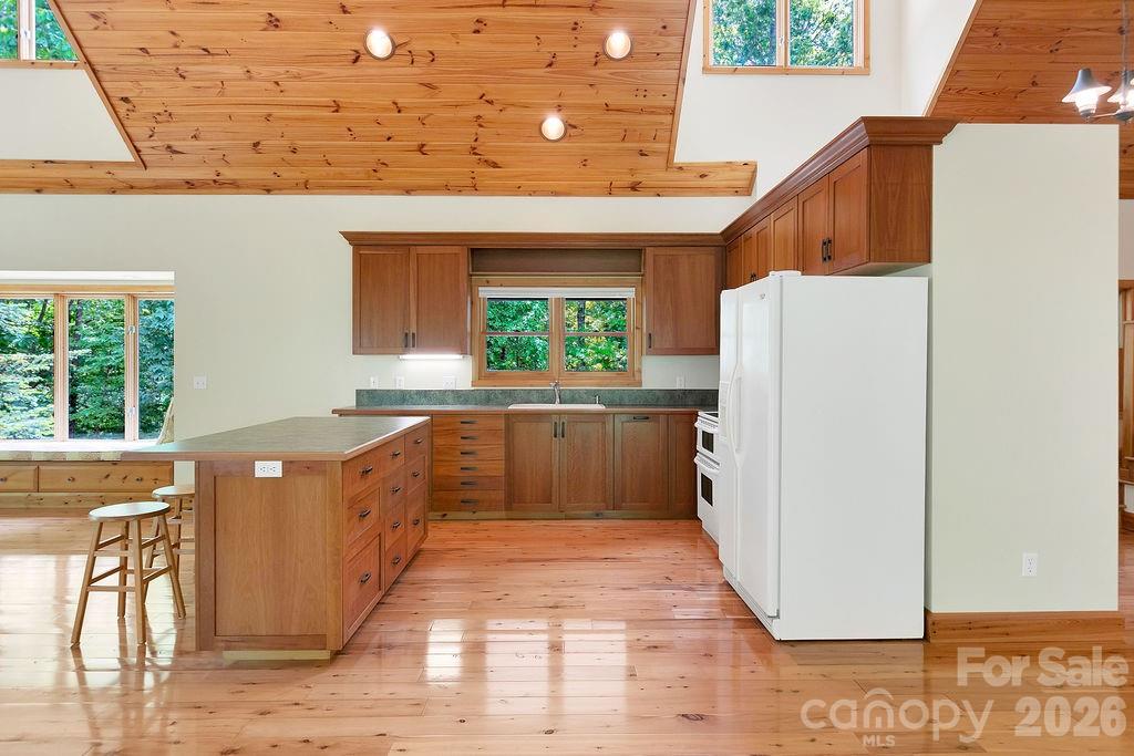 40 Walnut Ridge Road Brevard, NC 28712 - Photo 14 of 47 a kitchen with stainless steel appliances a refrigerator a sink a stove and wooden floor