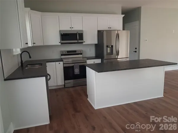 an empty room with wooden floor and closet