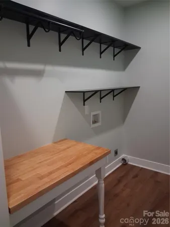 a view of a room with wooden floor