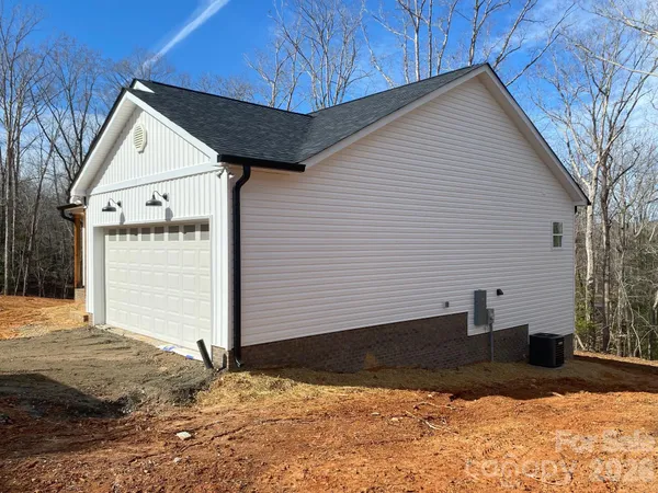 a front view of house with a yard and garage