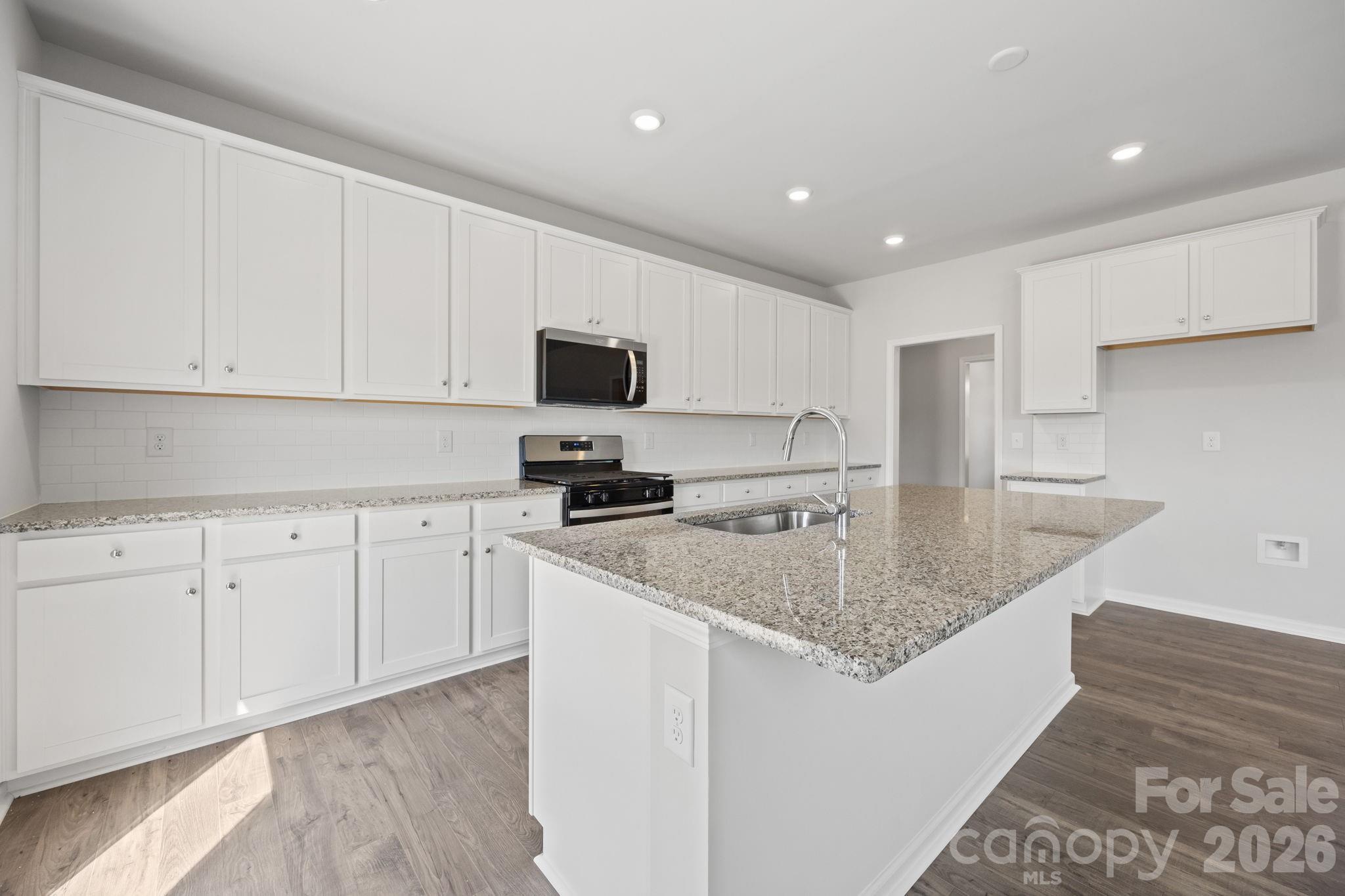 426 Brick House Road York, SC 29745 - Photo 14 of 35 a kitchen with stainless steel appliances granite countertop a sink a stove and a granite counter top